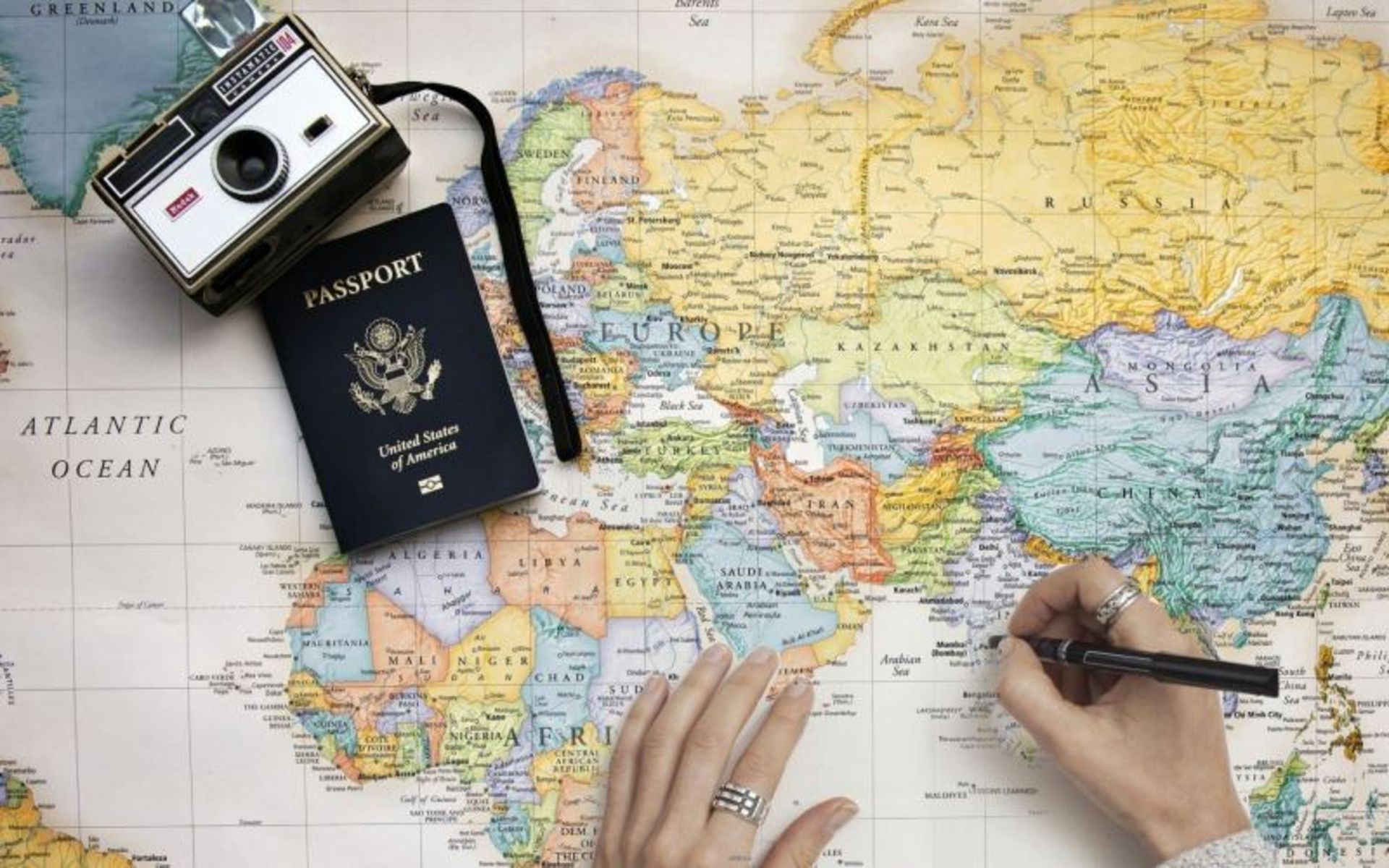 US Passport on the World Paper Map