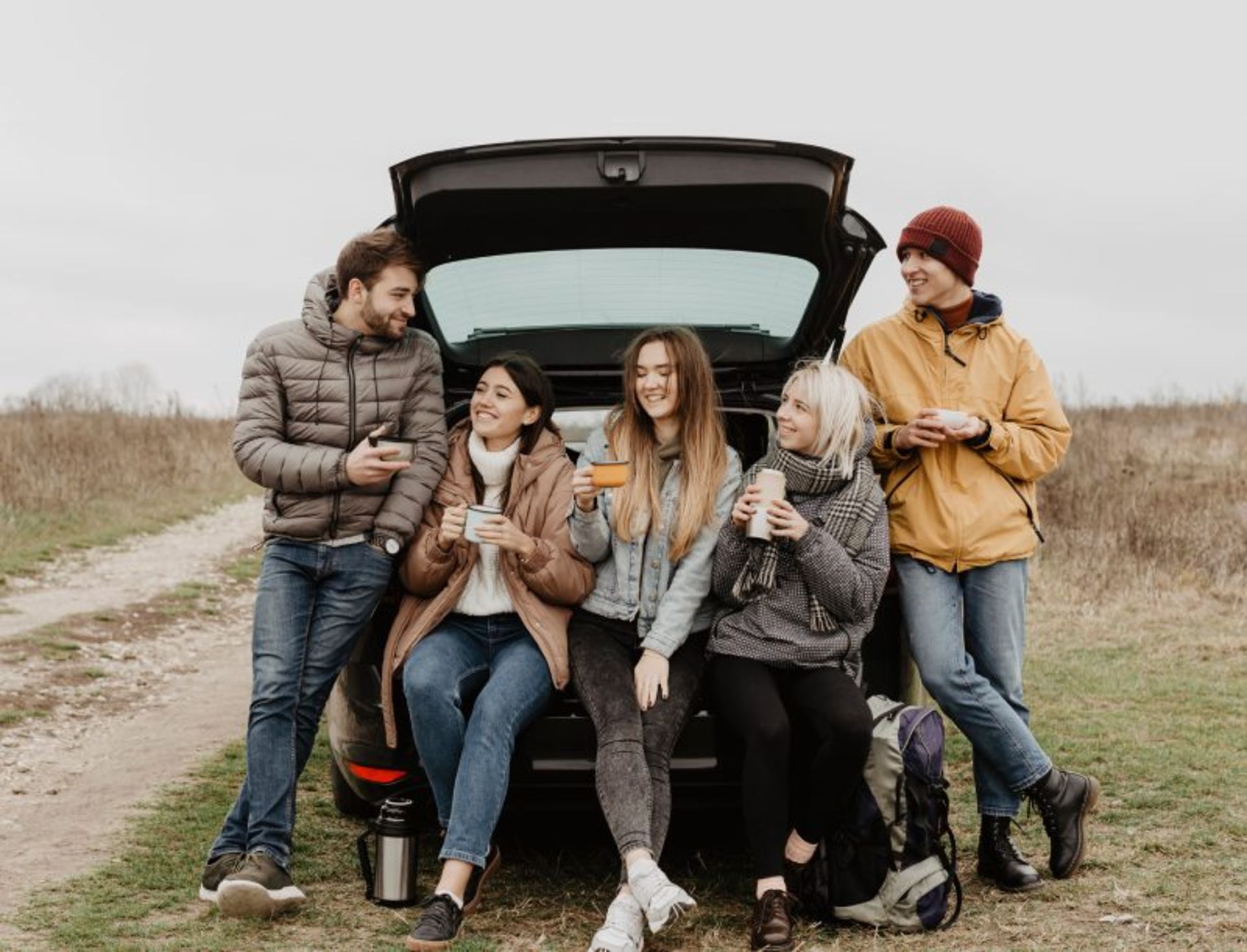 Tourists behind the car eating drink
