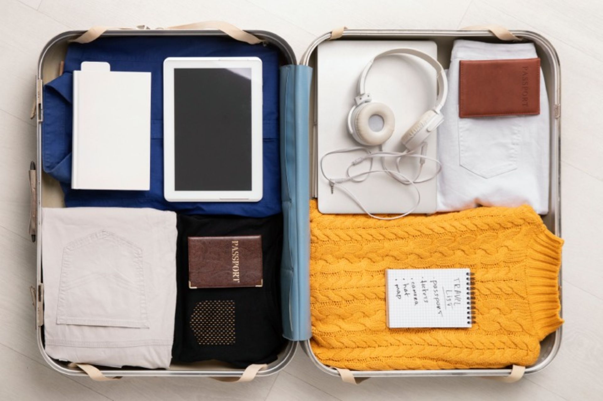 The various travel items inside the suitcase