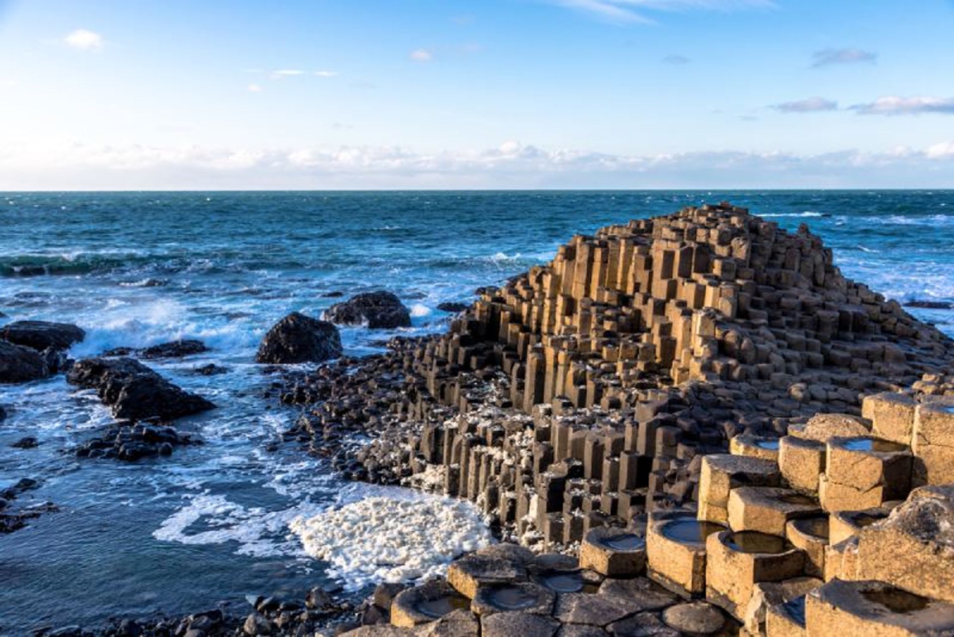 Black basin geometric columns on the sea on the gia crossing