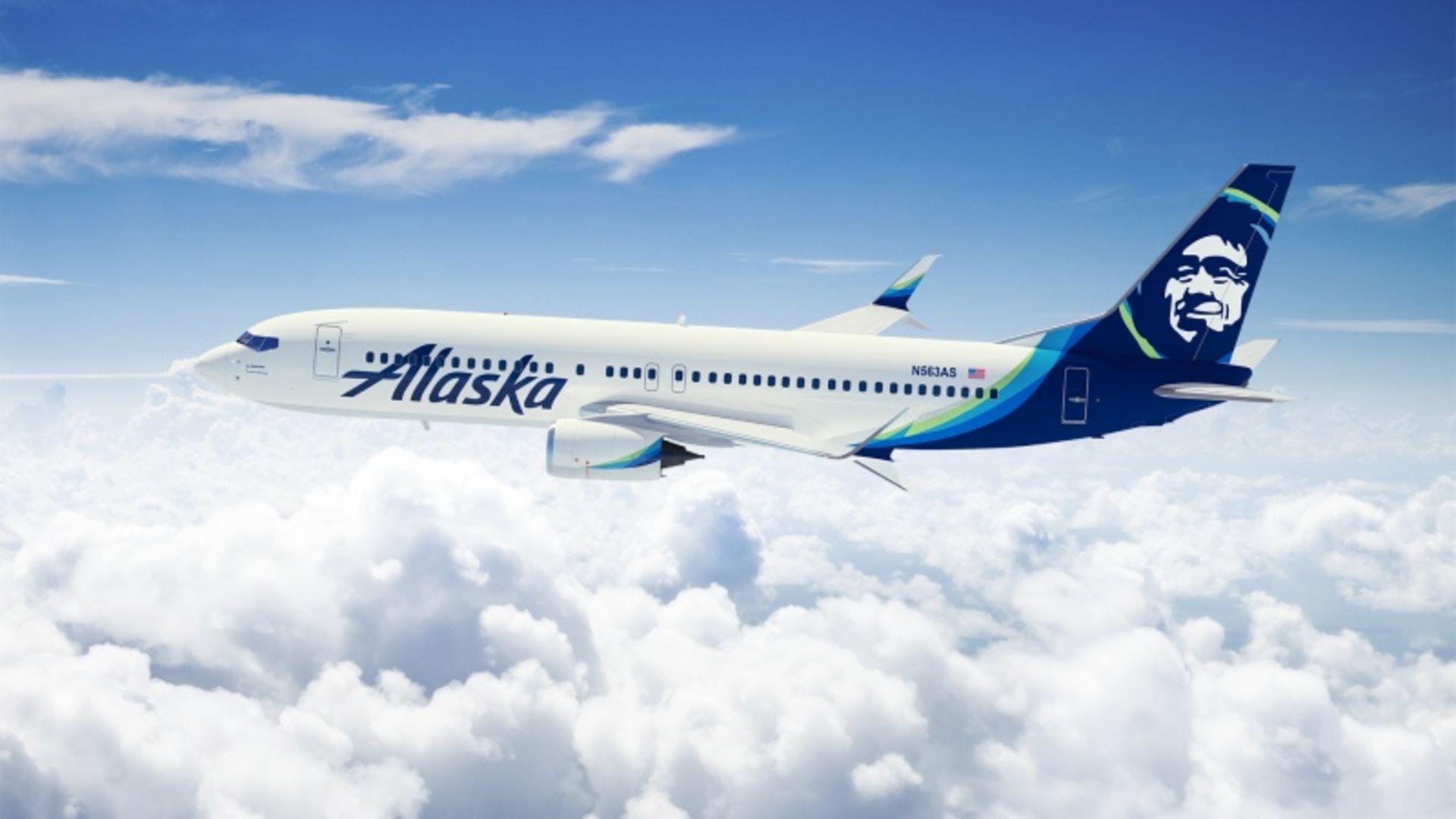 Alaska Airlines plane in the sky above white clouds