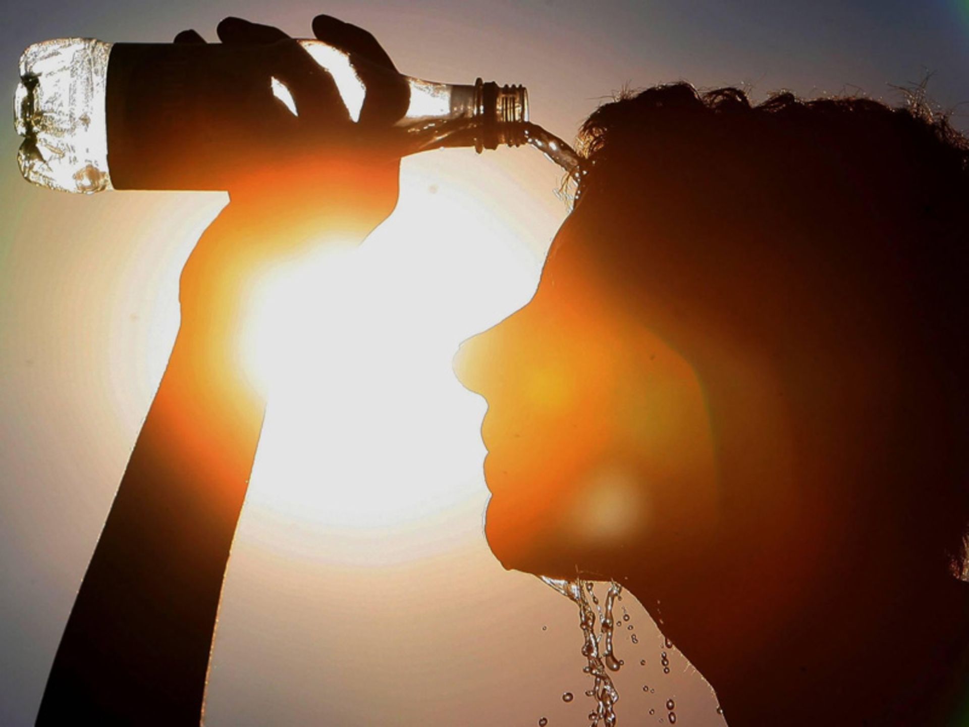 Pouring water on the face to preve heat