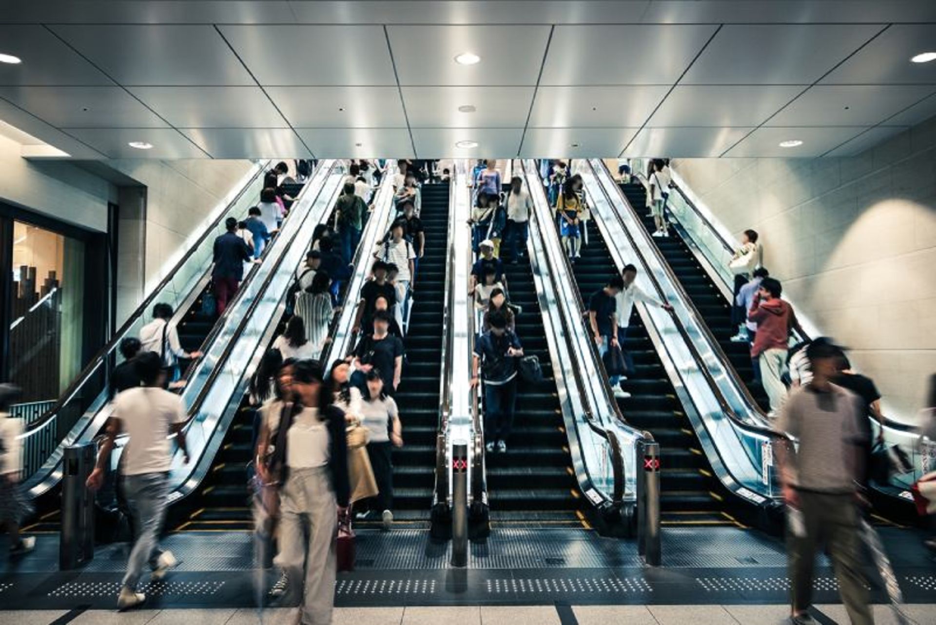 Men and women on escalators in Japan