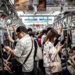 People are using the phone on the train in Japan