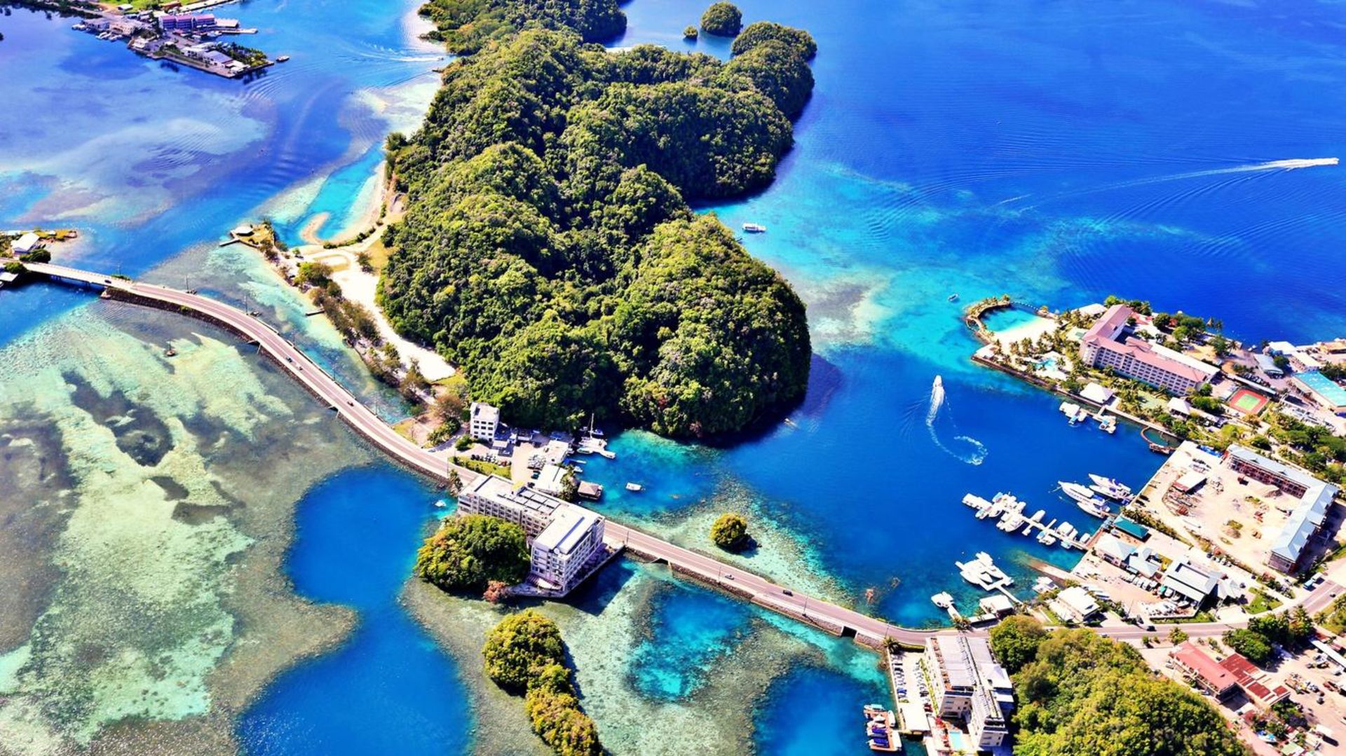 The blue ocean, buildings, green trees, roads and boats in palauo
