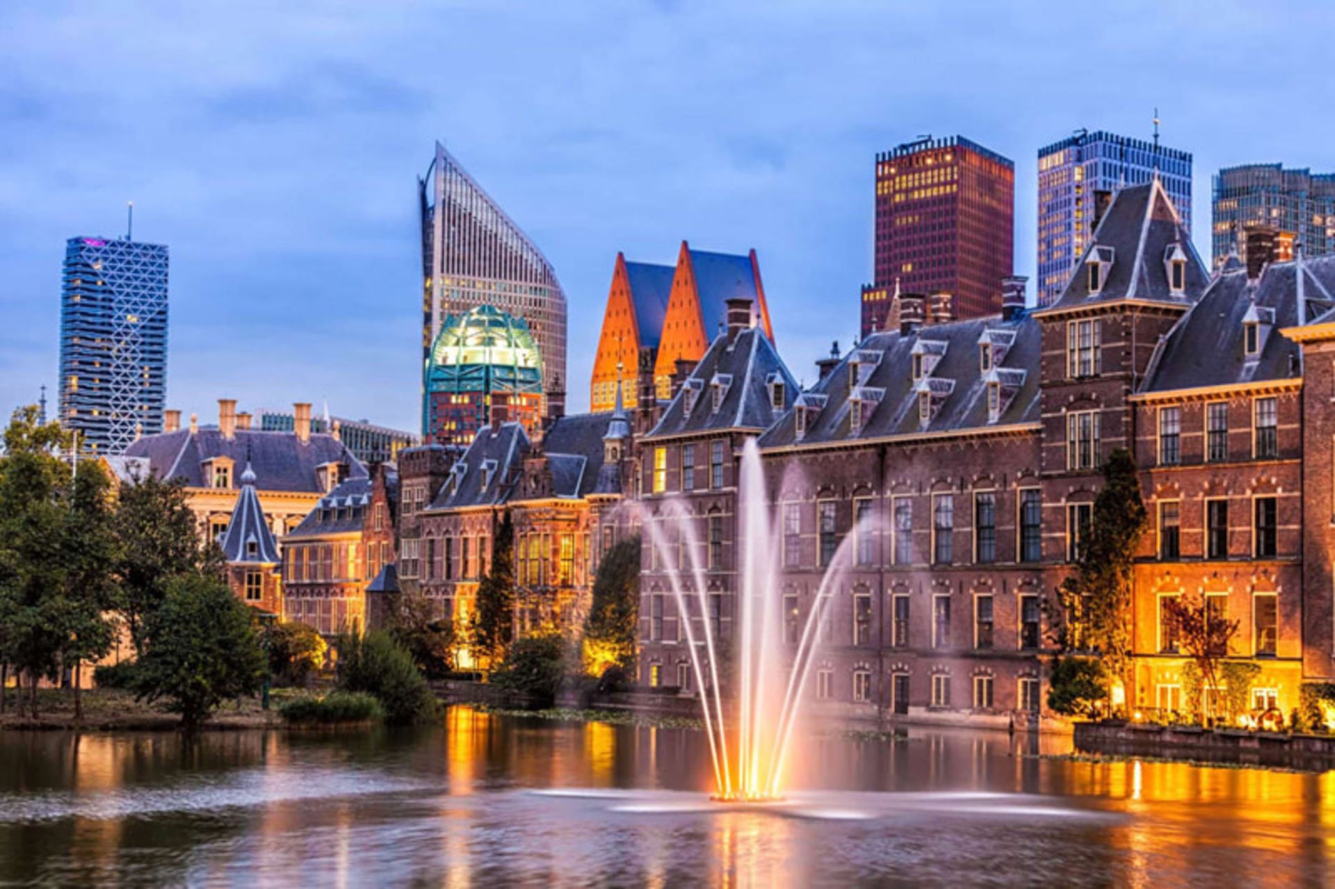 Hague at sunset with a bright fouain and historical buildings