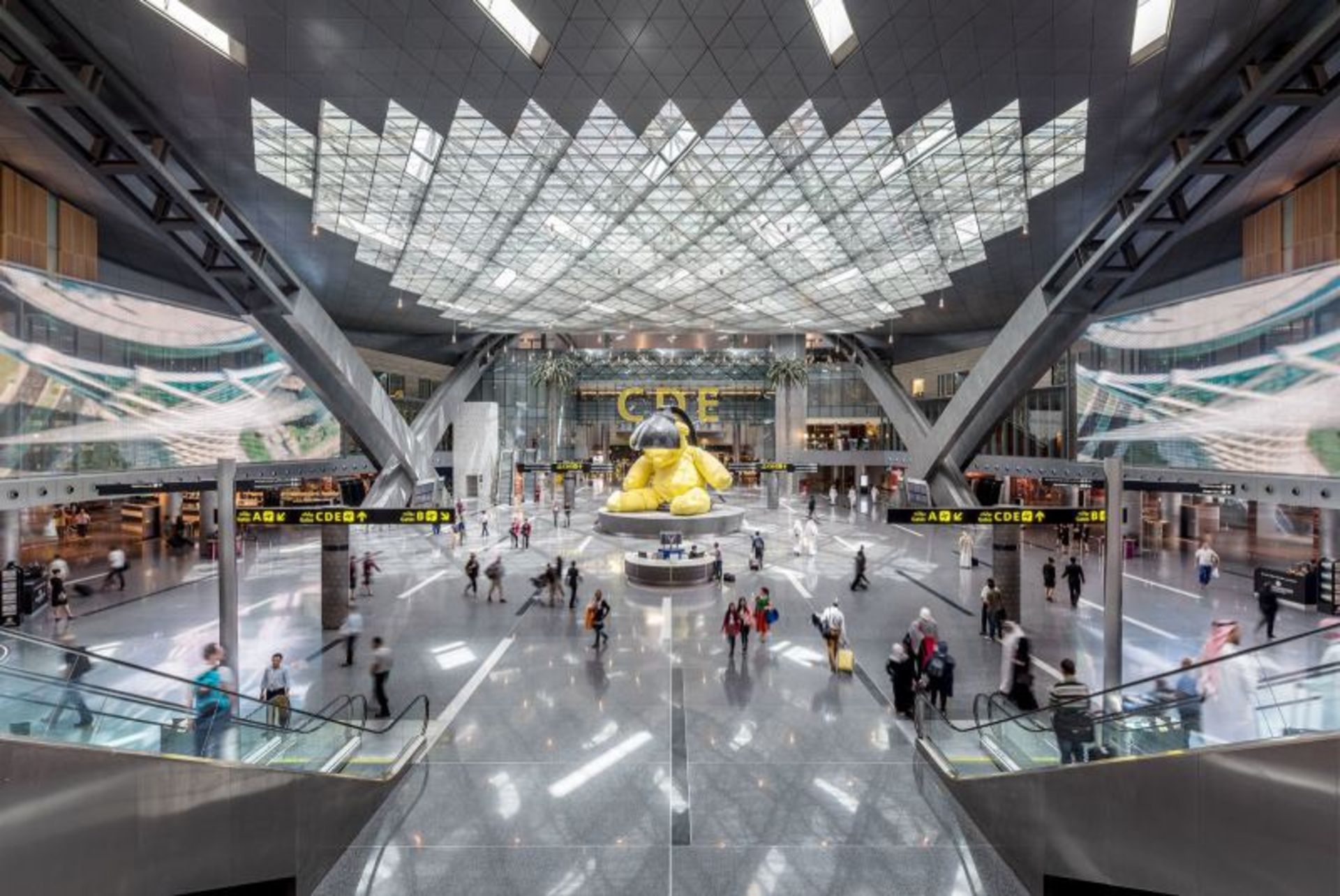 Golden bear and passengers at Hamad Iernational Airport 