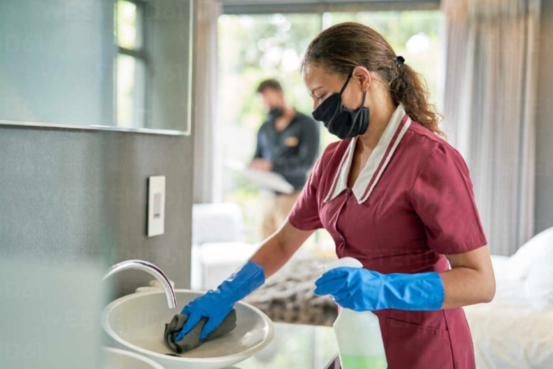 Women with special clothing, mask and gloves cleaning the wash