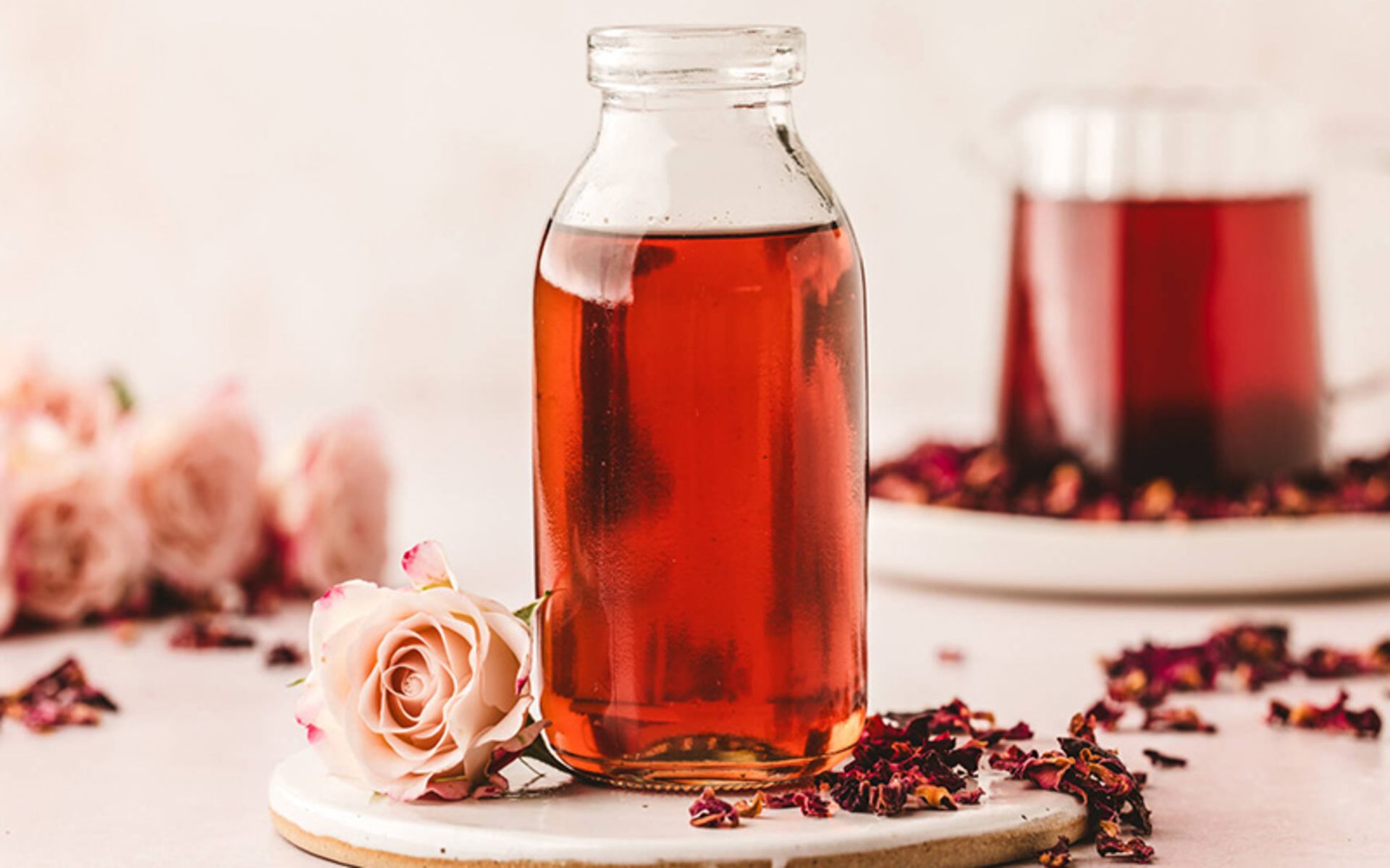 A glass of Mohammadi flower syrup with Mohammadi flowers