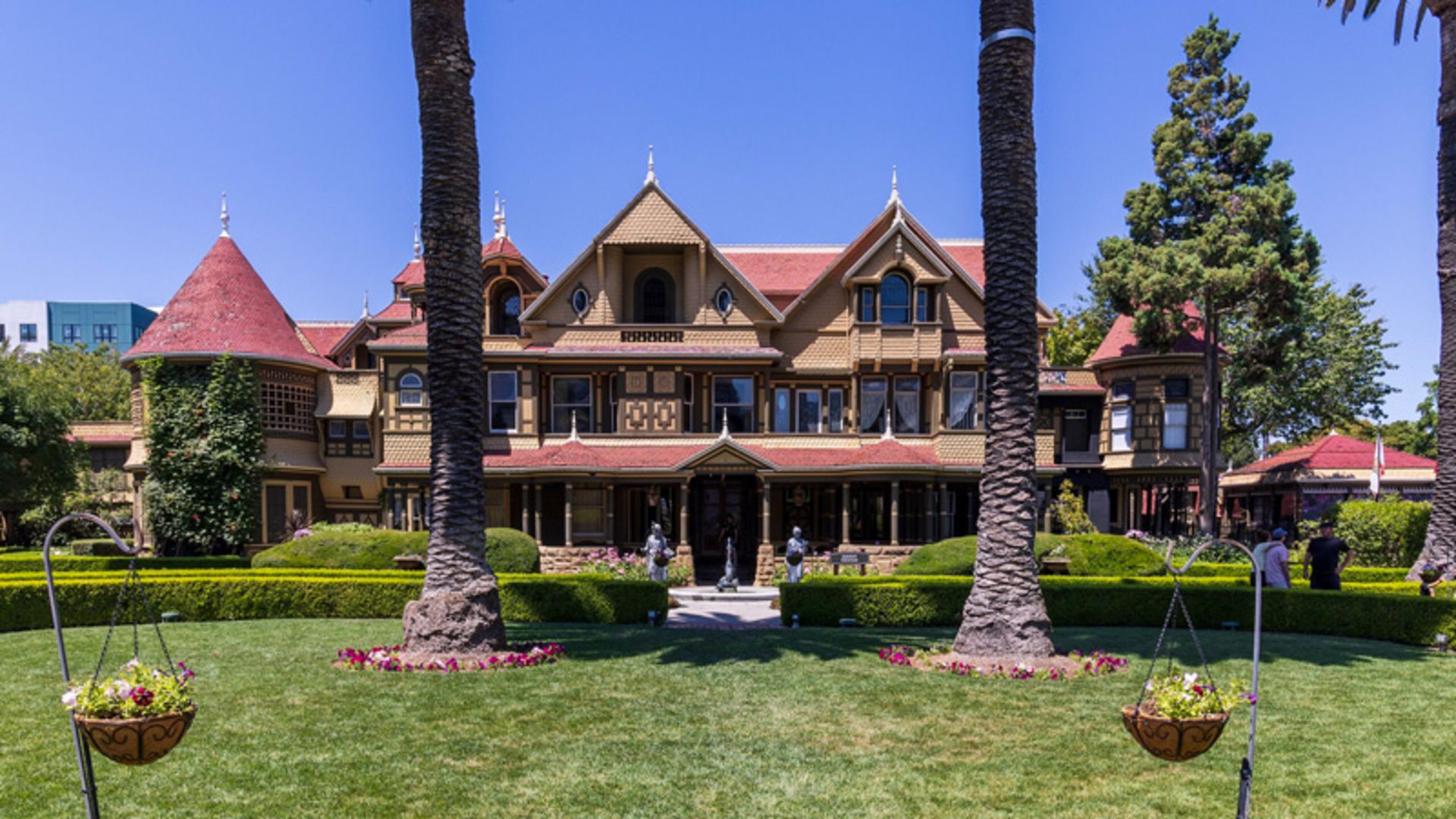 Winchester's house with a lush area and red facade