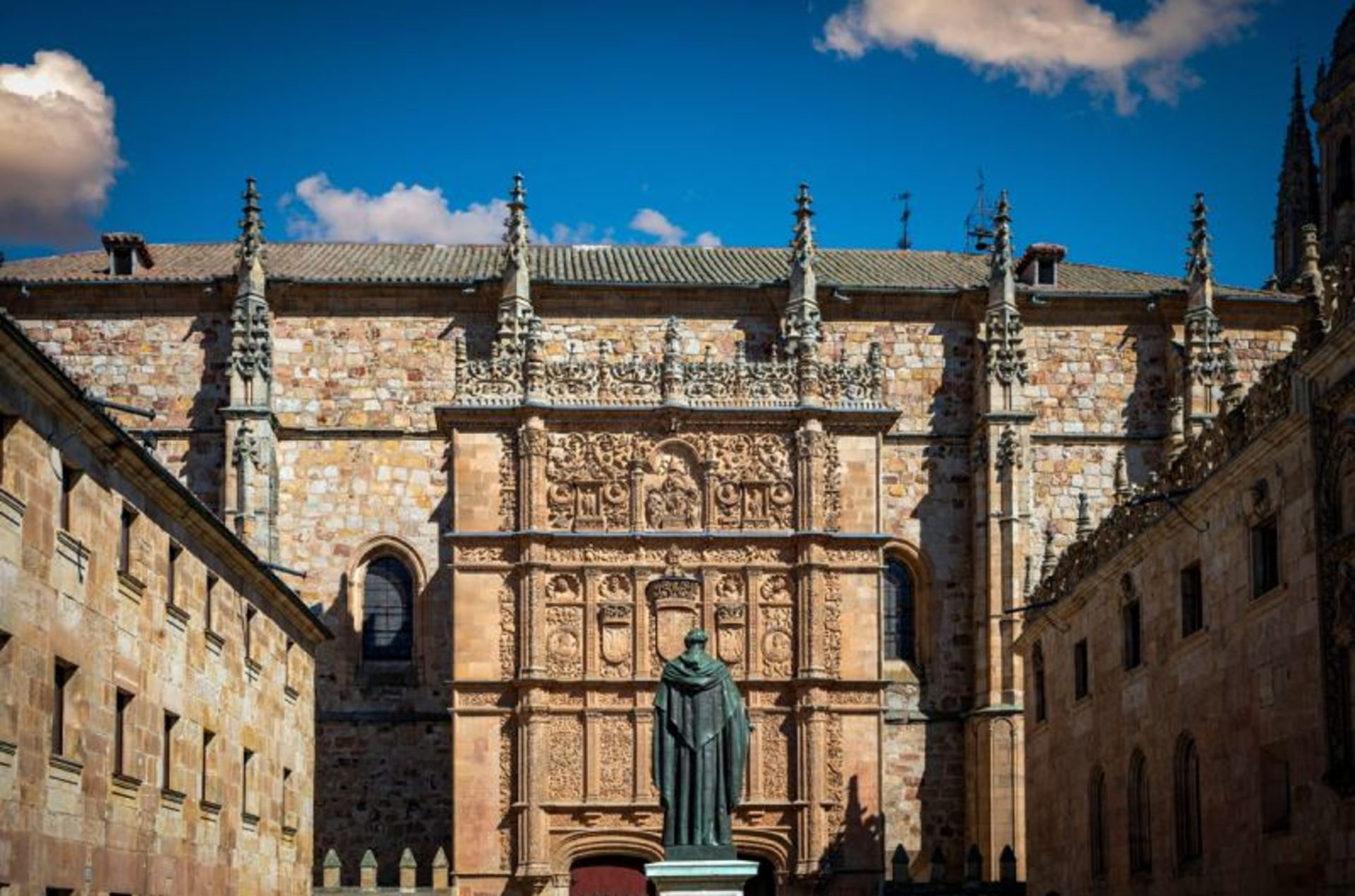 Building and Statue of Salamanka University on sunny day