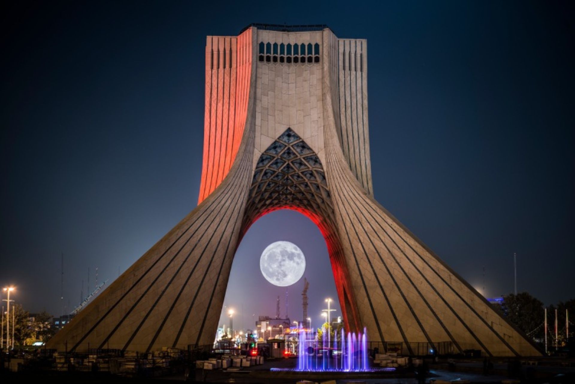 Tehran Freedom Tower at night next to the moon 