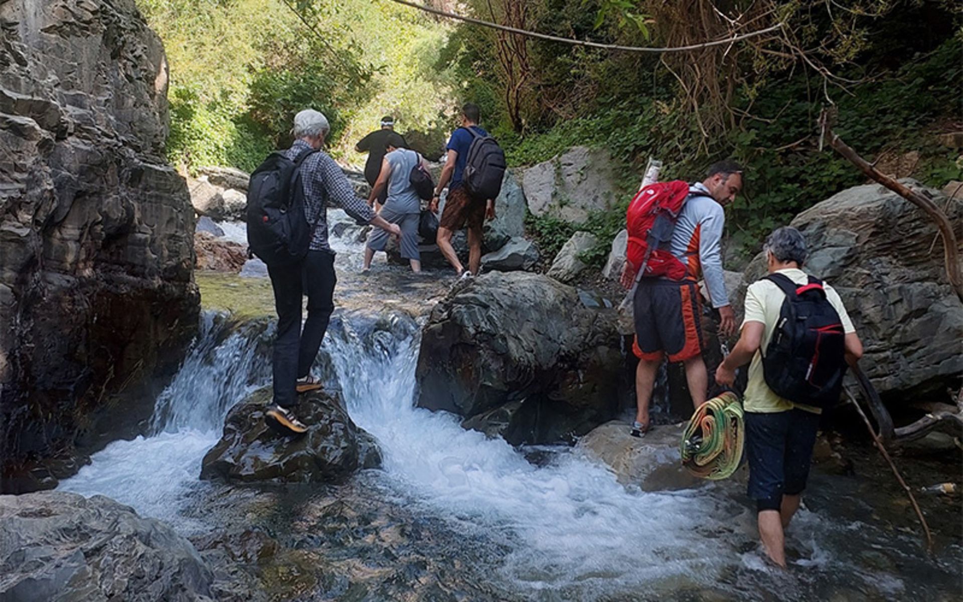 Tourist climbing river in Siban Dara waterfall