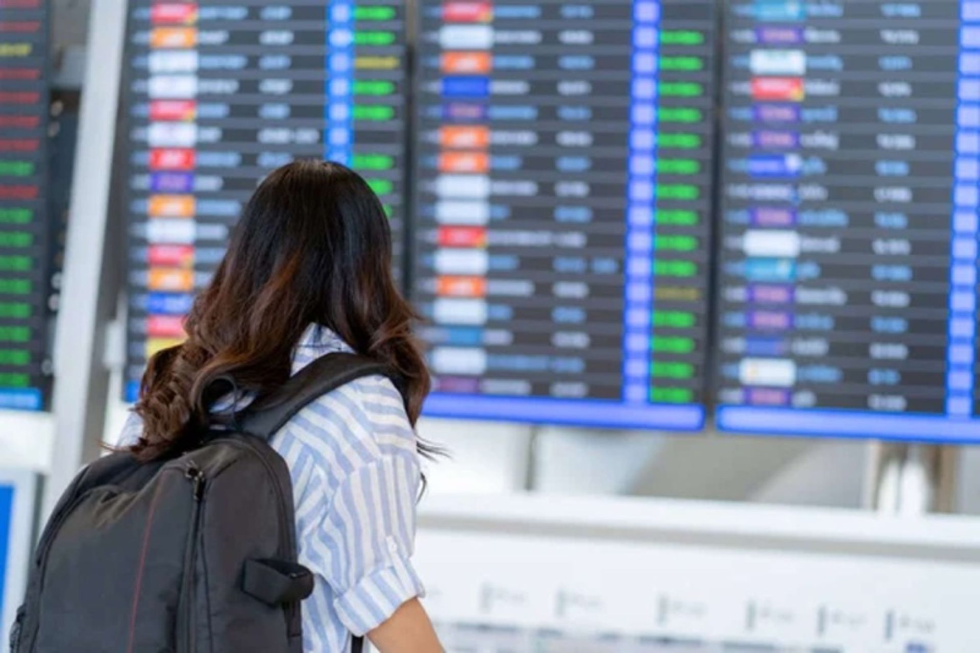 Woman's passenger watching the airport display