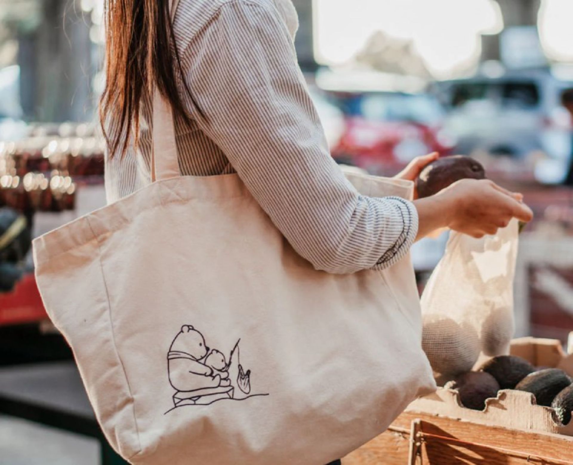 A woman who is shopping with a fabric sack