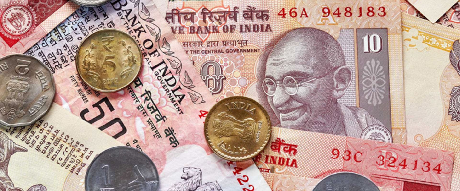   Indian Rupee banknotes and coins with Gandhi image