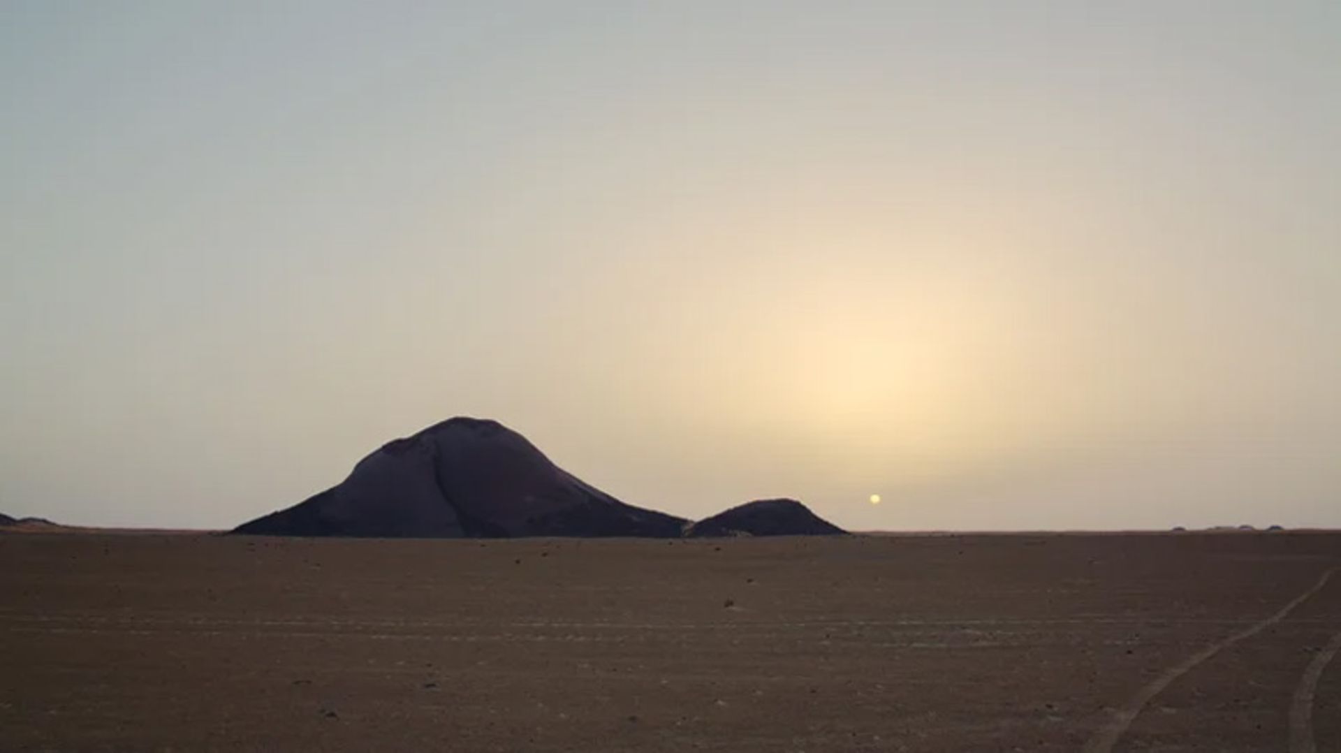 Monolite bin Amirah in the Great Sahara of Africa at sunset