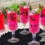 Pink Mohammadi flower syrup with ice and mint leaves