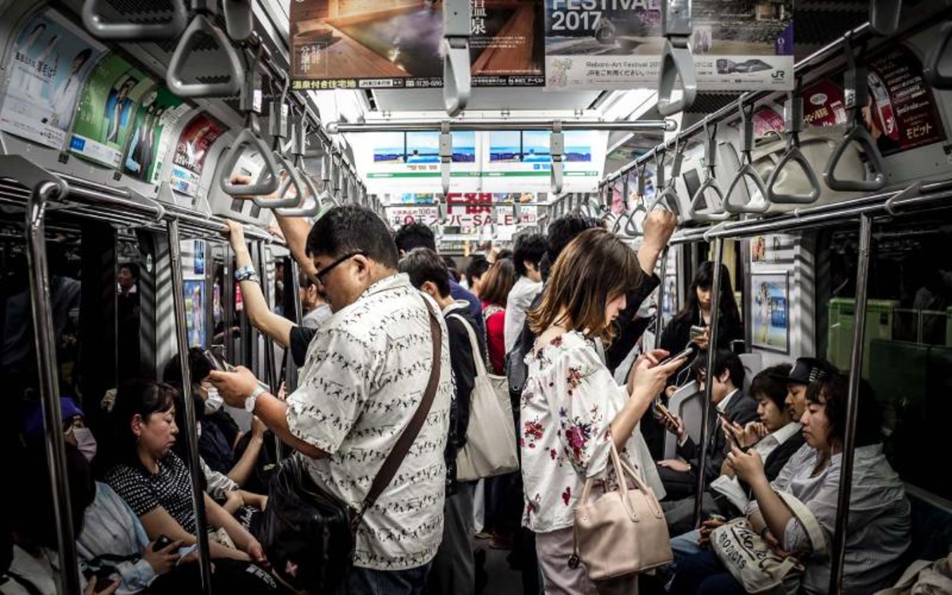 People are using the phone on the train in Japan