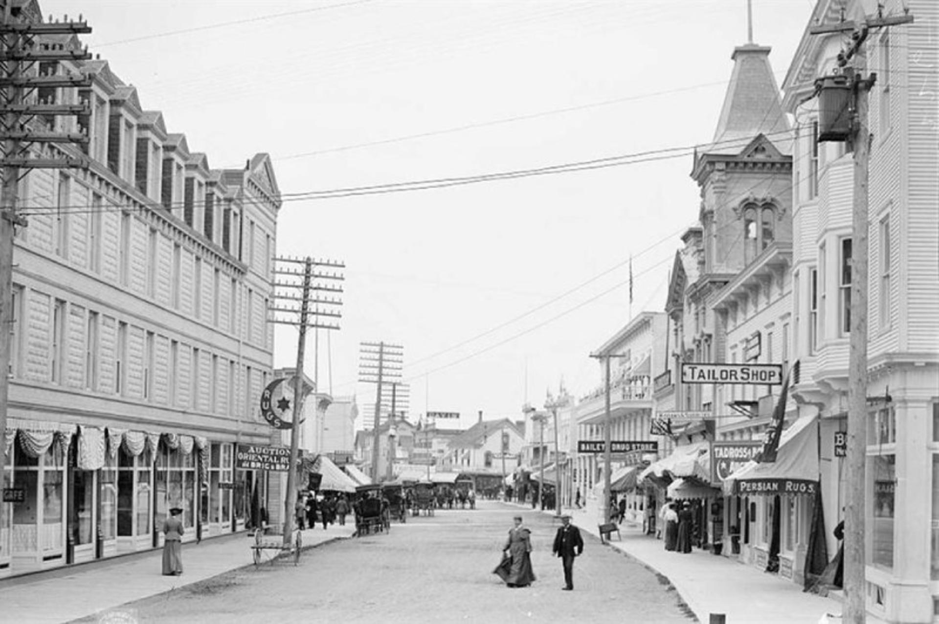 Old image of people and buildings on the main street of McKinak Island 