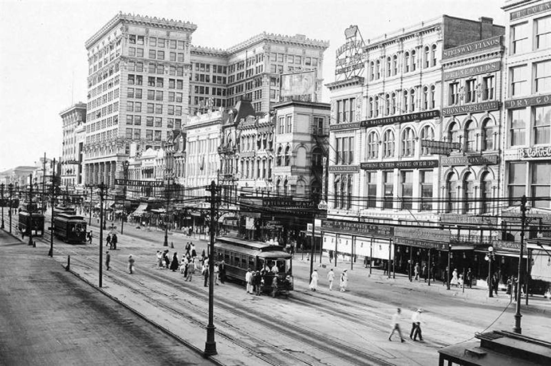 An old image of tram, people and buildings on New Orleans Channel Street 