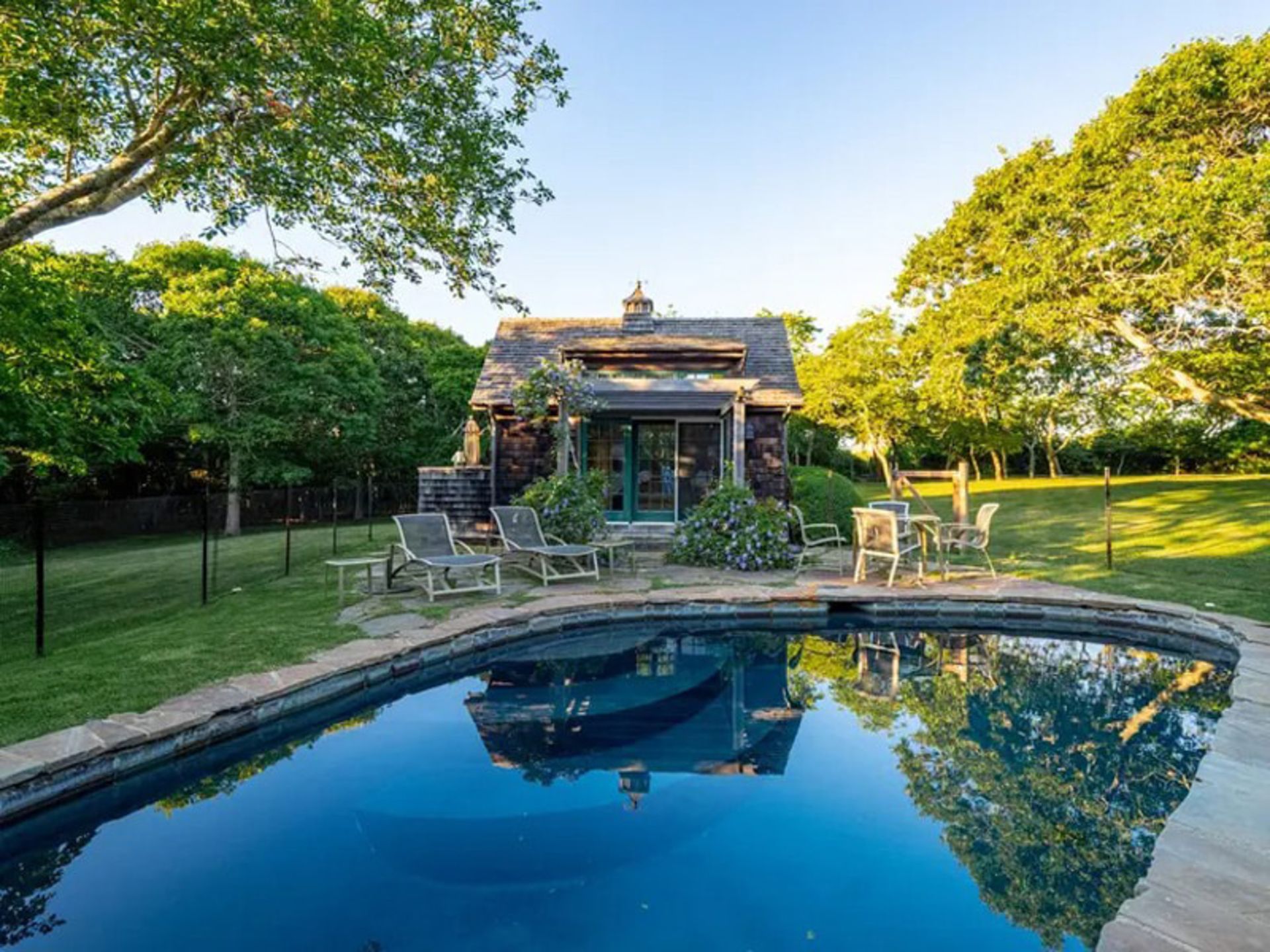 Moavak stone mansion pool in the middle of the lush yard