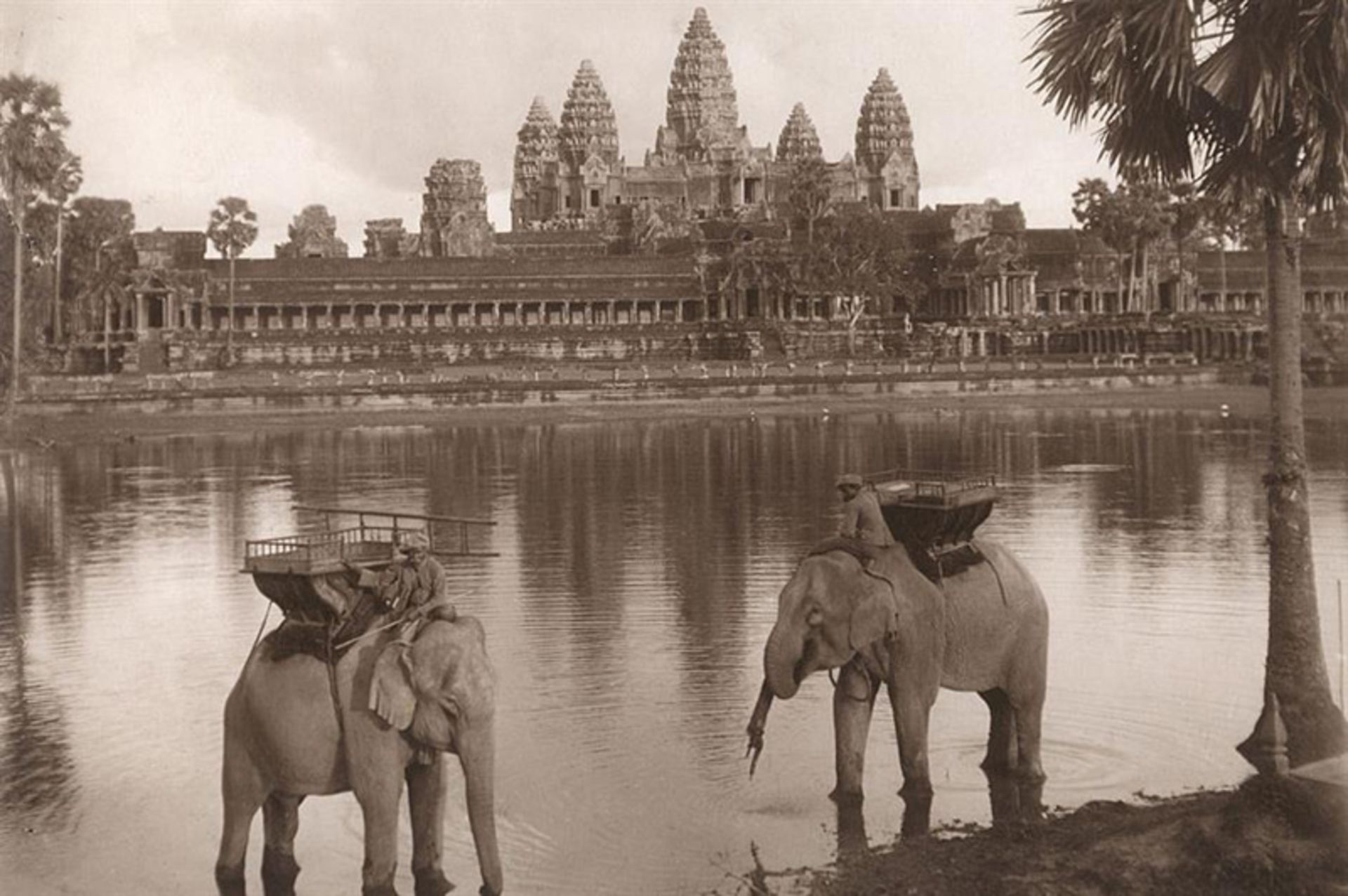 Old photo of two elephas by the lake and in fro of Angkor Wat, Cambodia