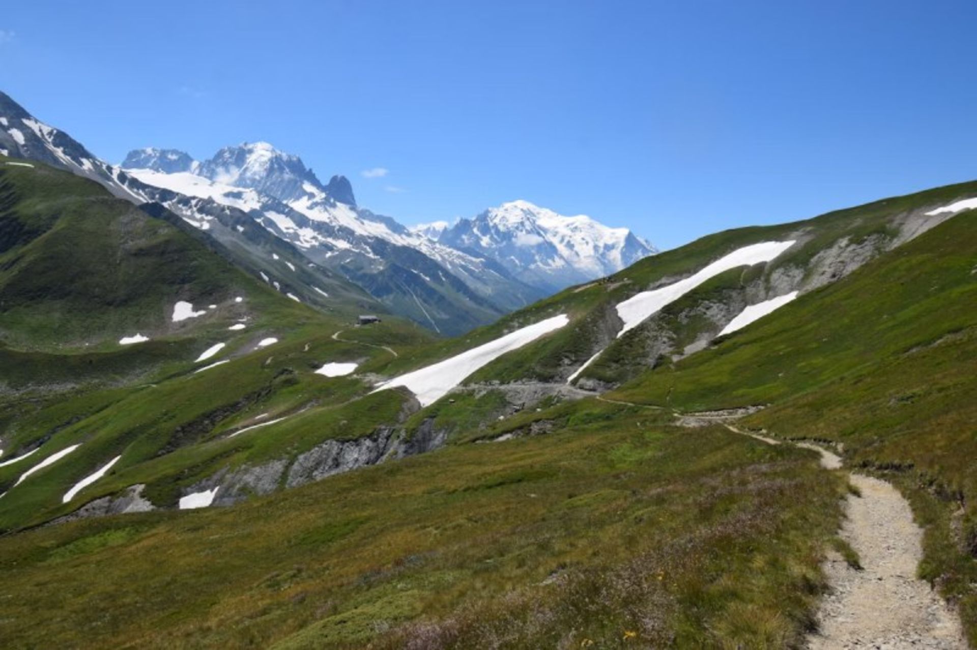 Lush nature and snowy mouains on the hiking track 