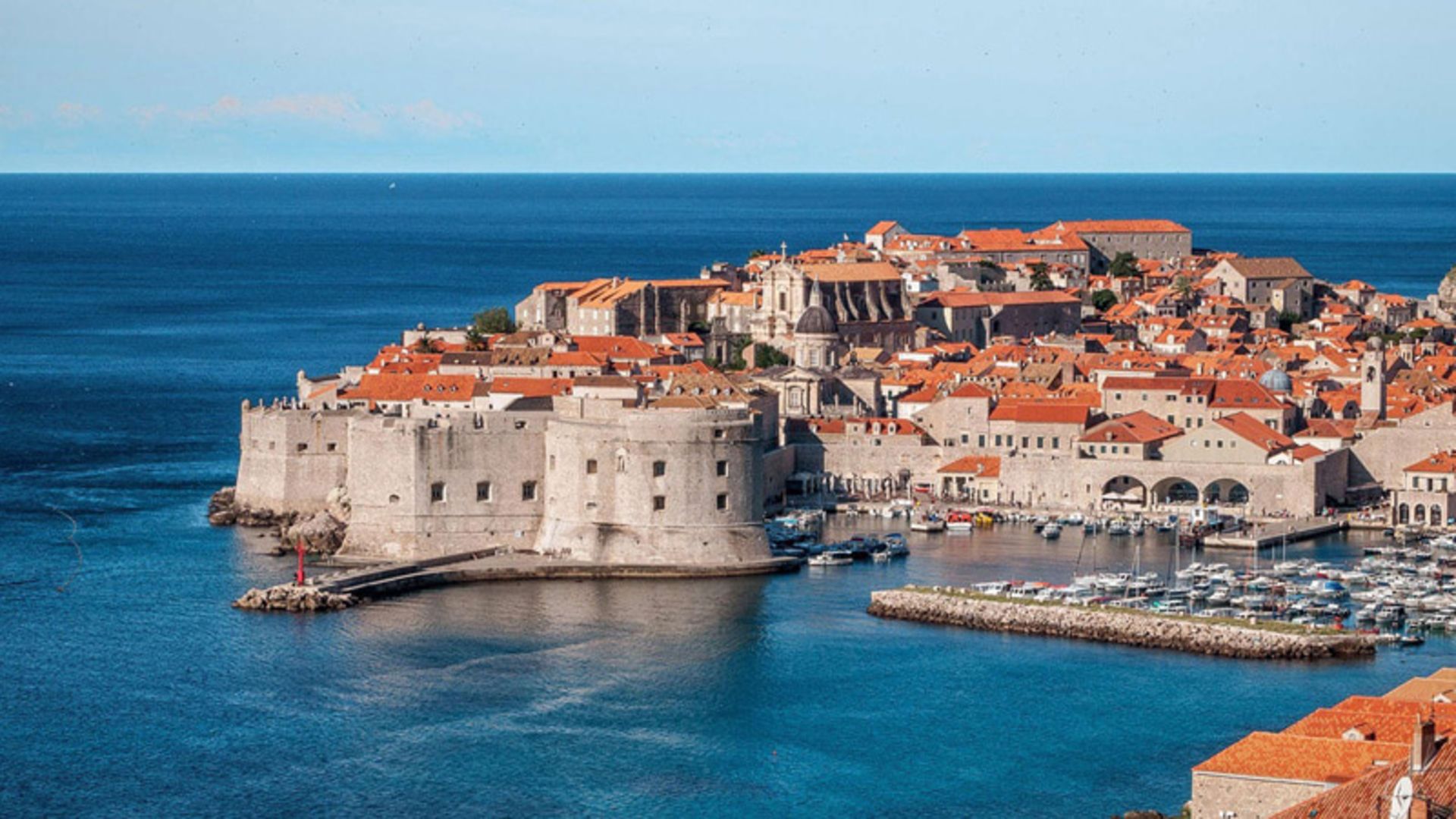 Homes with orange ceiling along the turquoise waters of Dubrovonik, Croatia