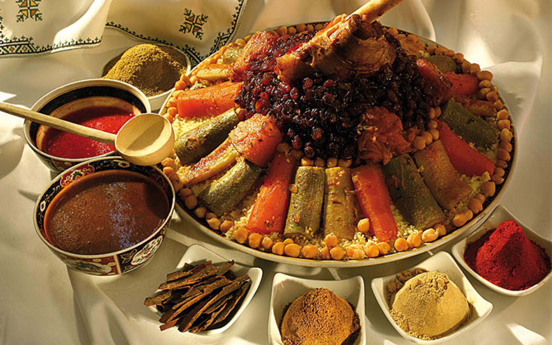 Cuscus plate alongside differe spices