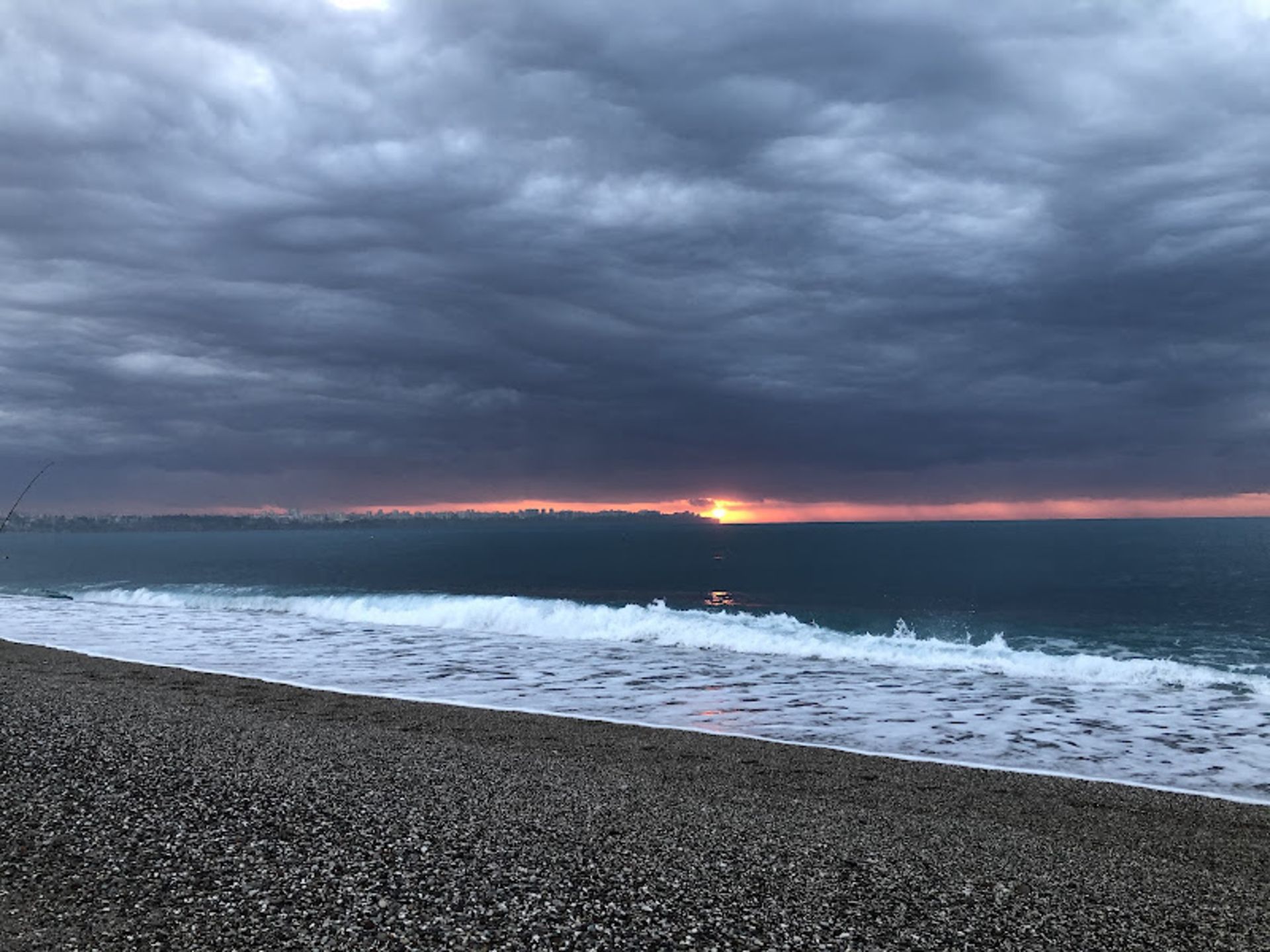 Sunset and cloudy sky on the coast of Aalya