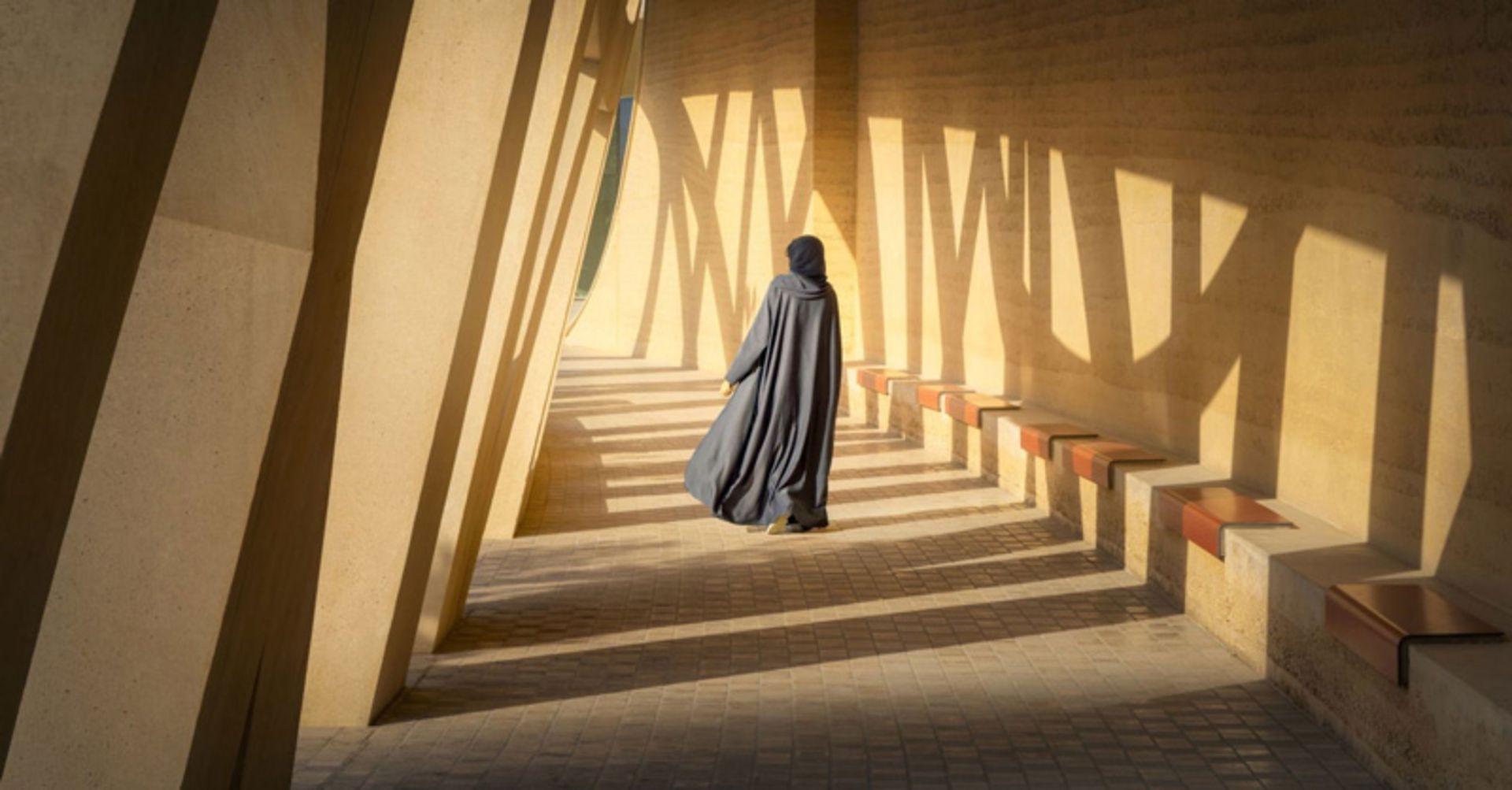 A visitor wearing a hijab walking in the cultural ceer of Atra