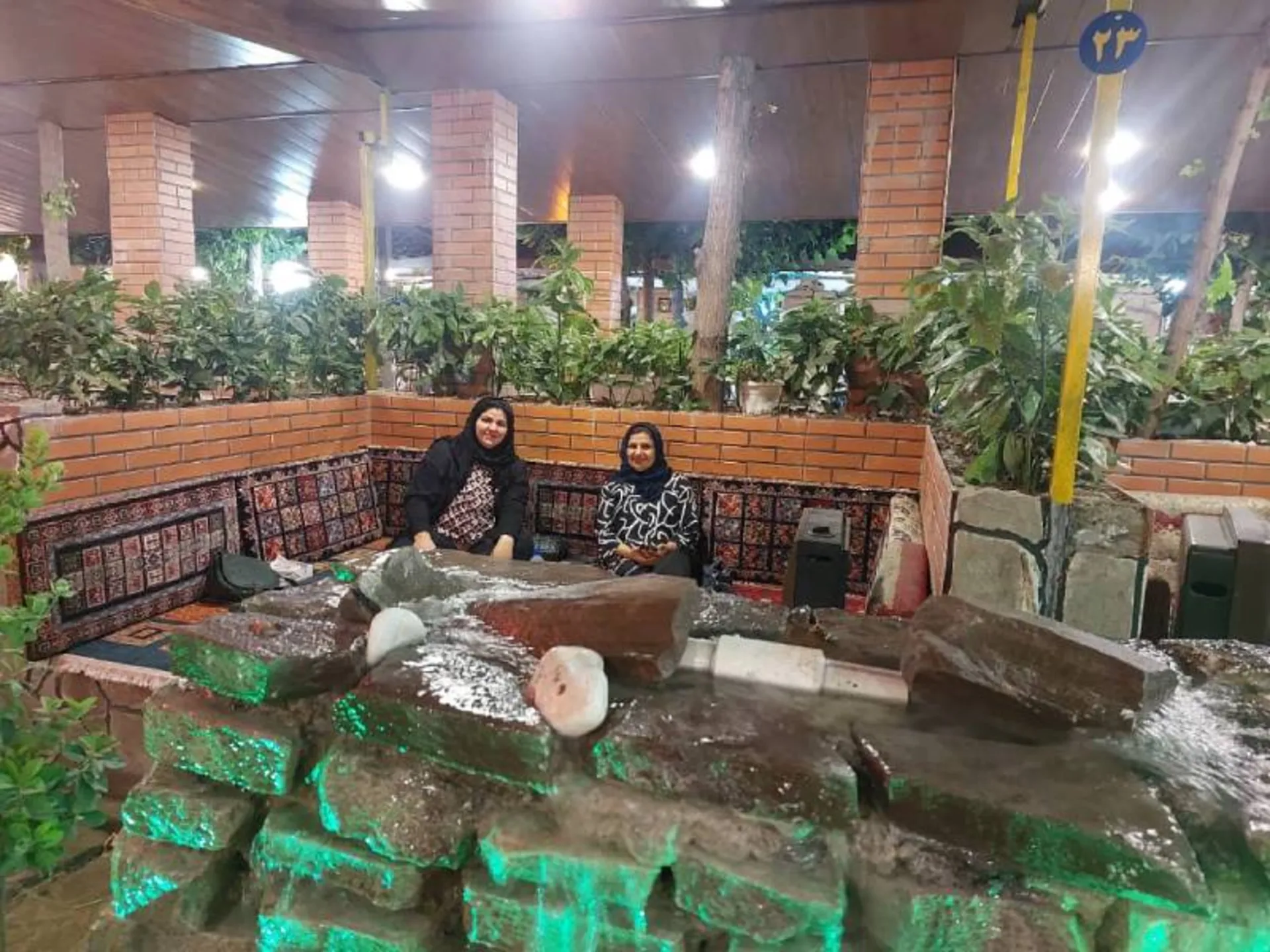 The beds and greenery of the traditional restaura of Farahzad Farm