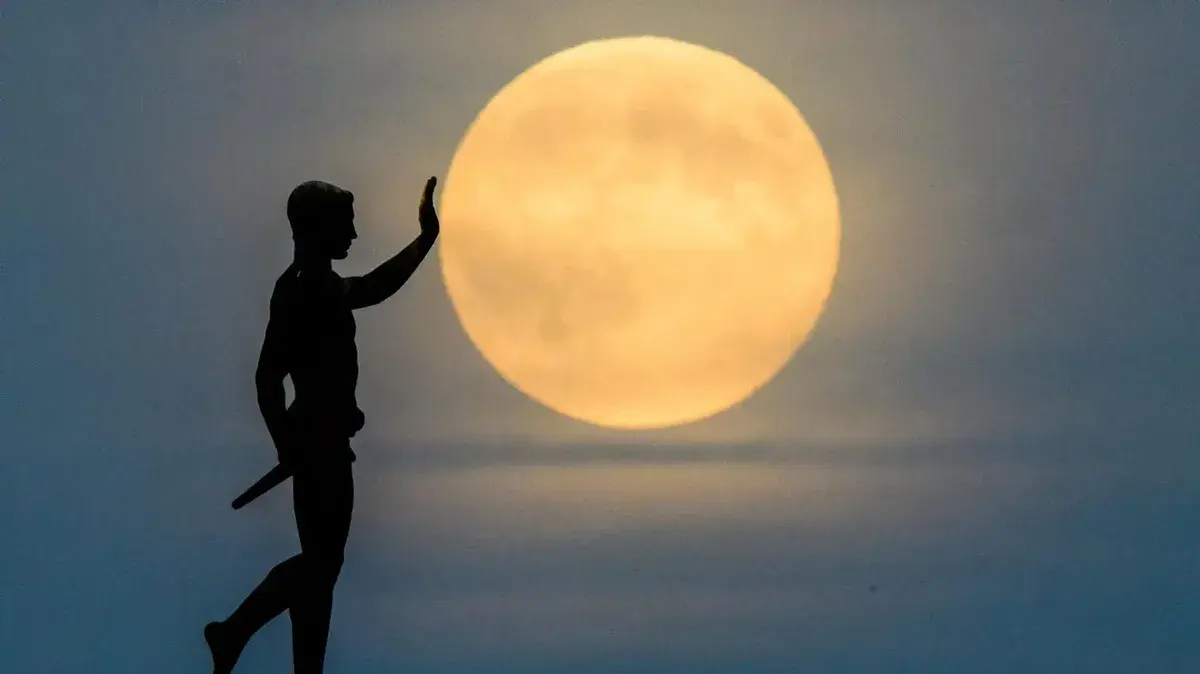 Full moon and pioneer torch statue