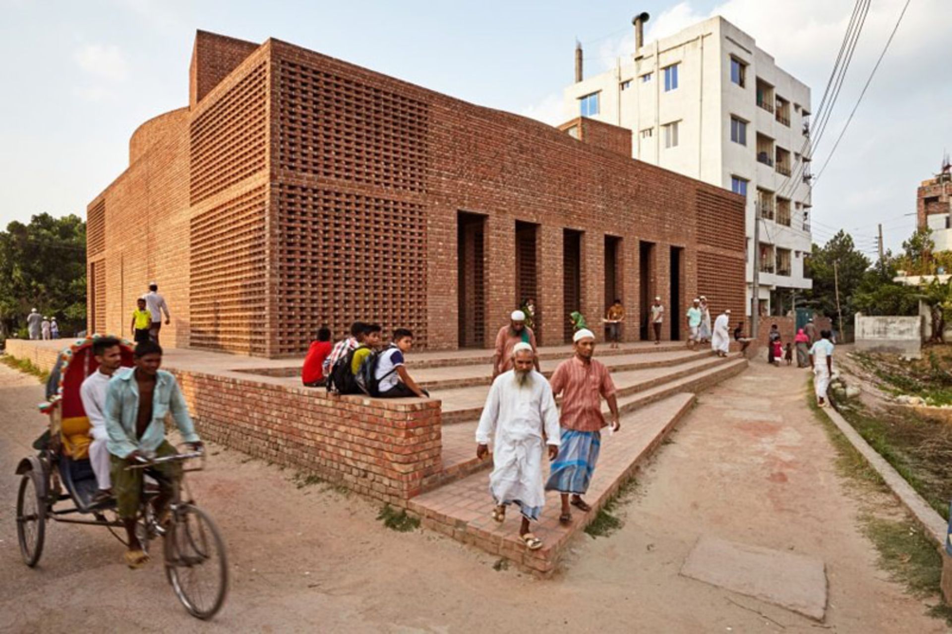 People around the brick building of Beit Al Rouf Mosque in Bangladesh