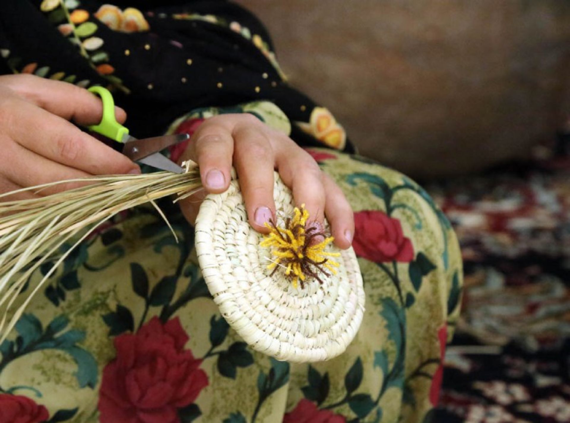 A woman weaving Marivan mats
