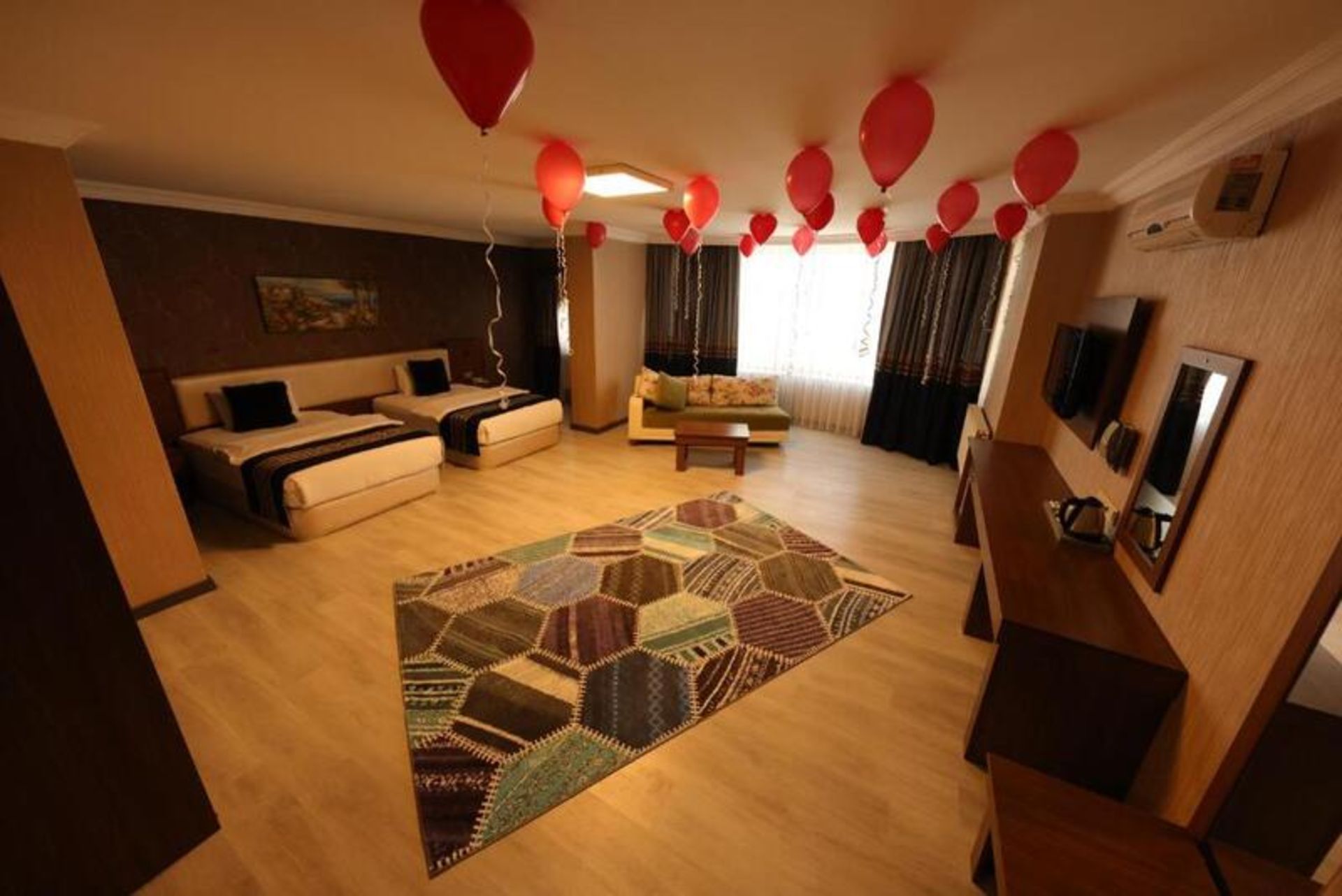 Royal Burke hotel room decorated with red balloons
