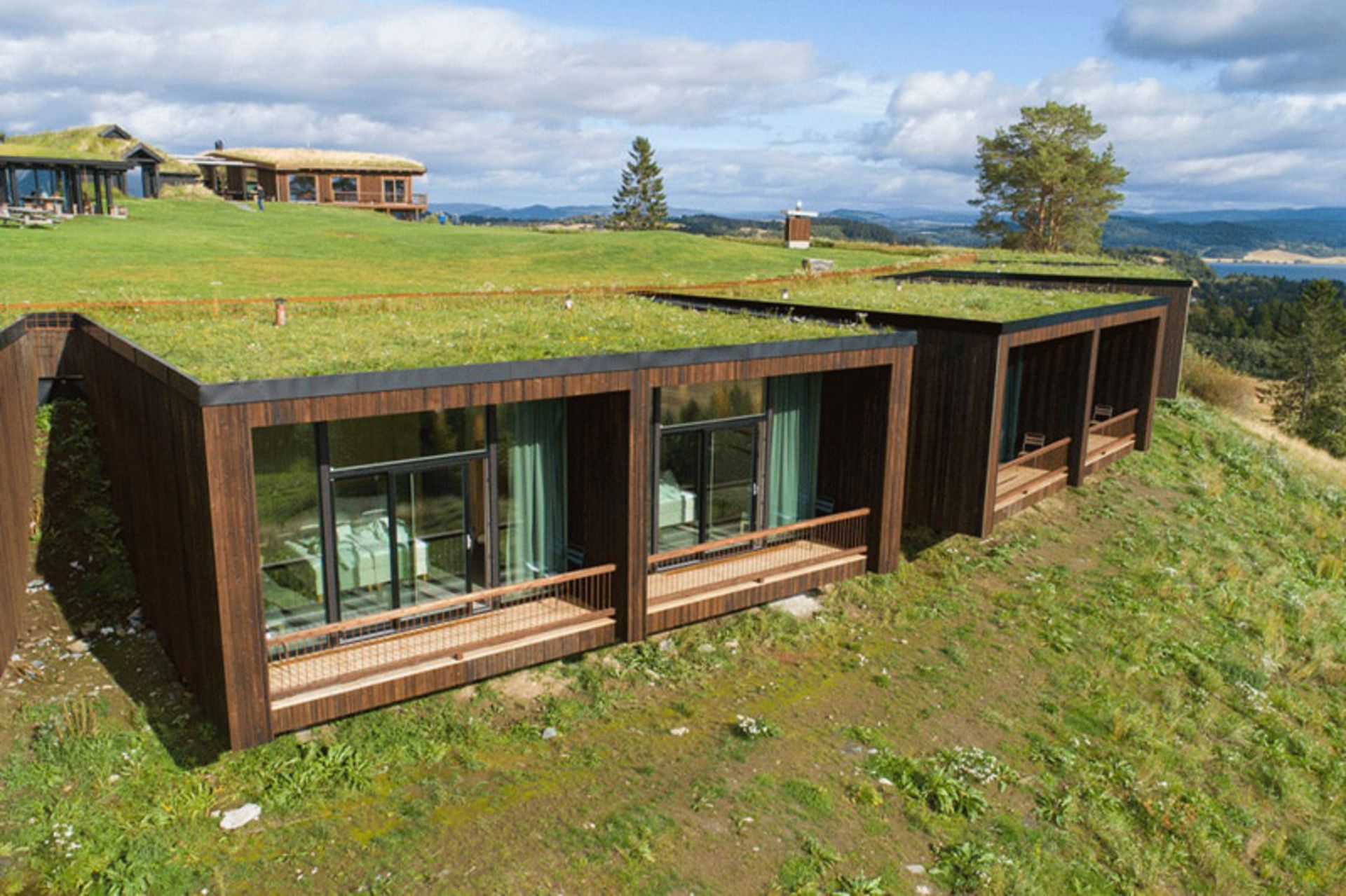 Wooden rooms with green roofs of Hotel Uina, Norway