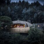 Night view of Bisate Hotel traditional villa in Rwanda