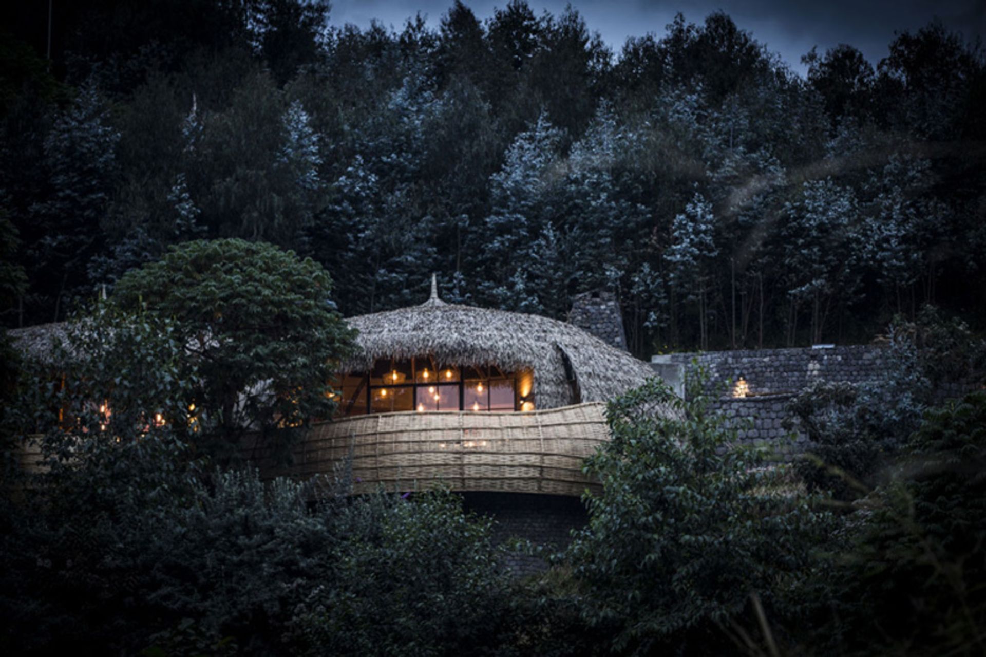 Night view of Bisate Hotel traditional villa in Rwanda