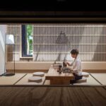 The tea table in the Blue Lake Teahouse, with a wooden lattice wall and a long window