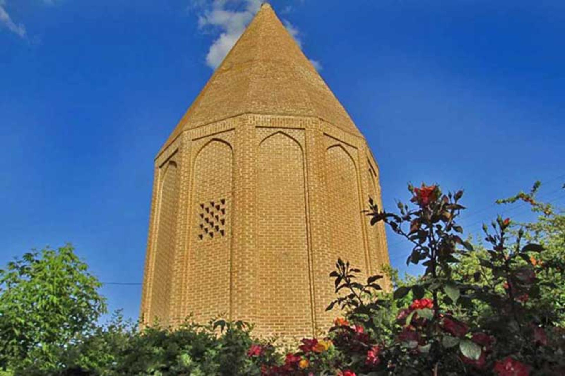 Gurban Hamadan tower among the green trees