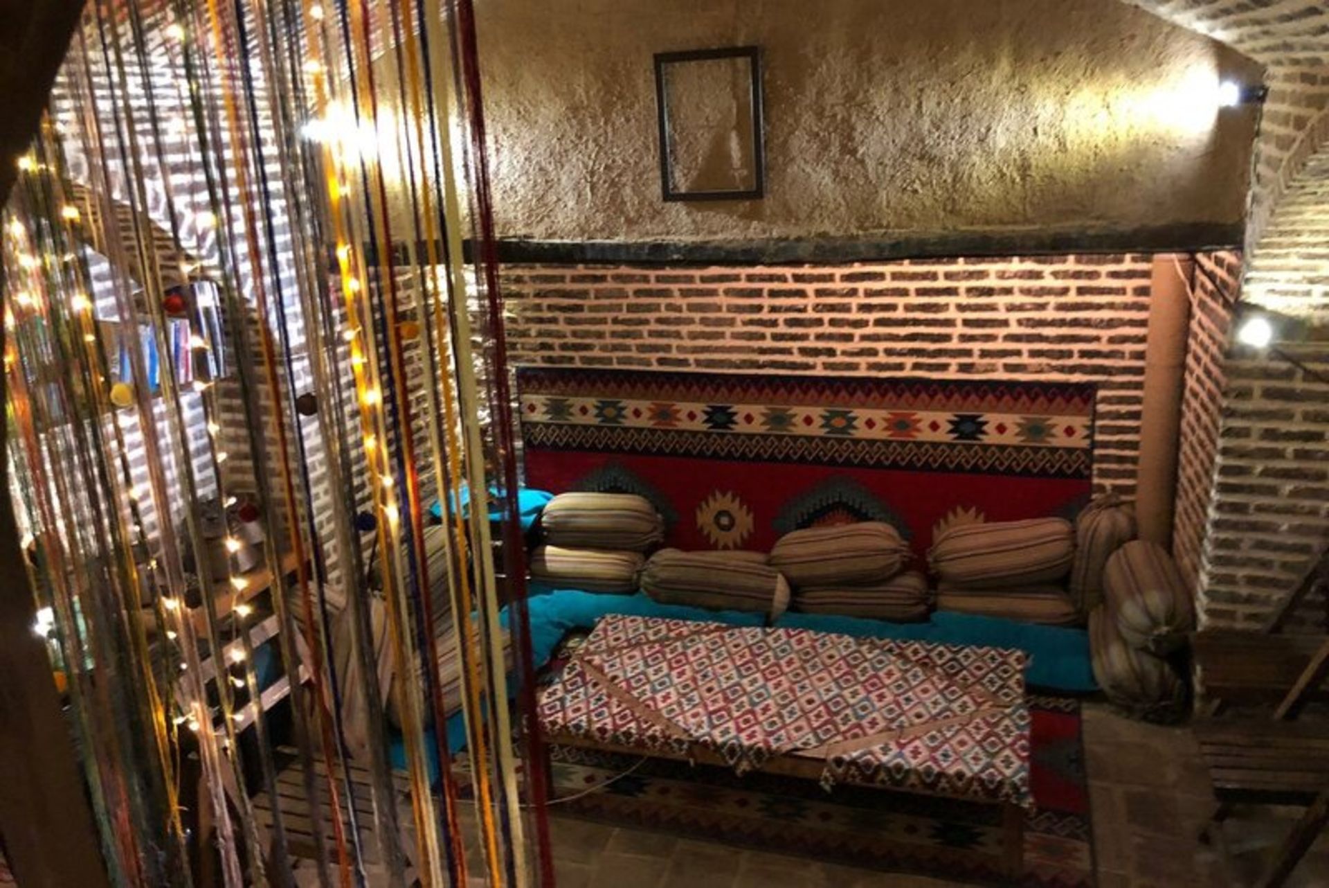 Bed and pillow in traditional hotel Behrouzi House Qazvin