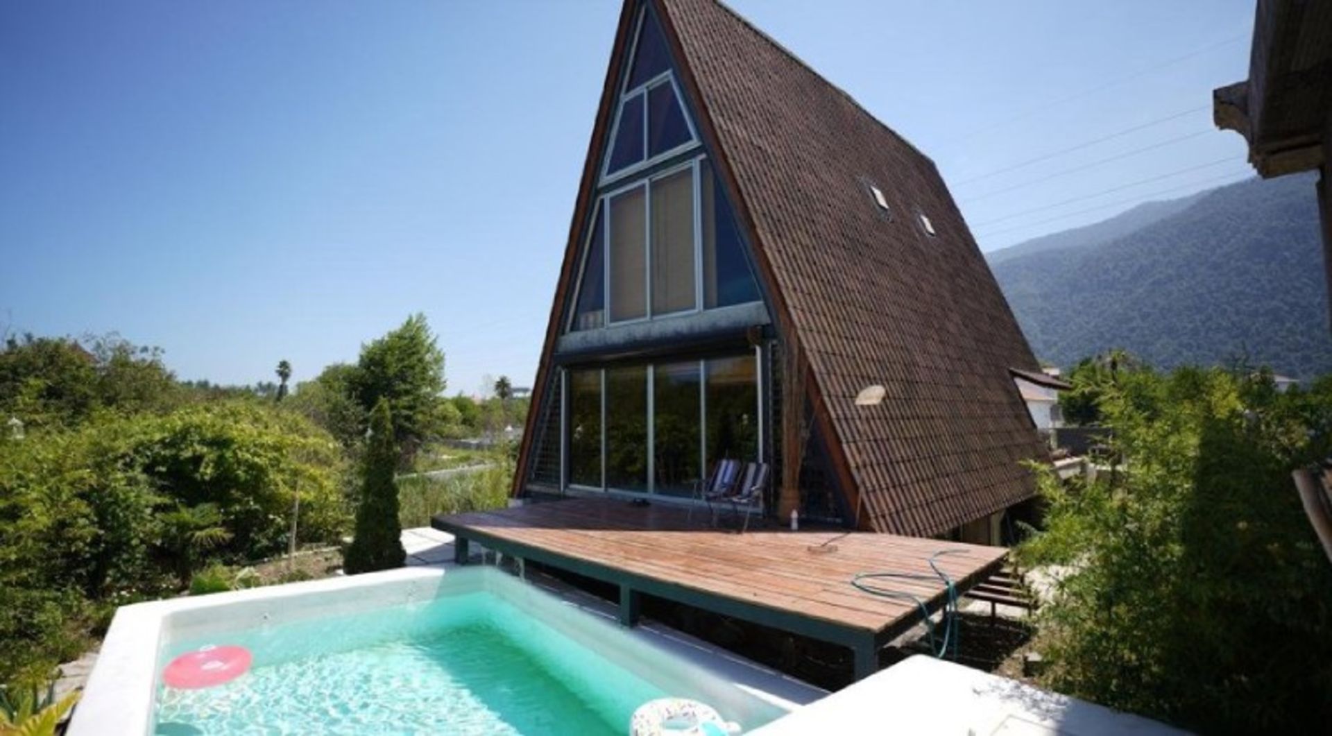 The outdoor swimming pool of the Swiss cottage of Nowshahr life