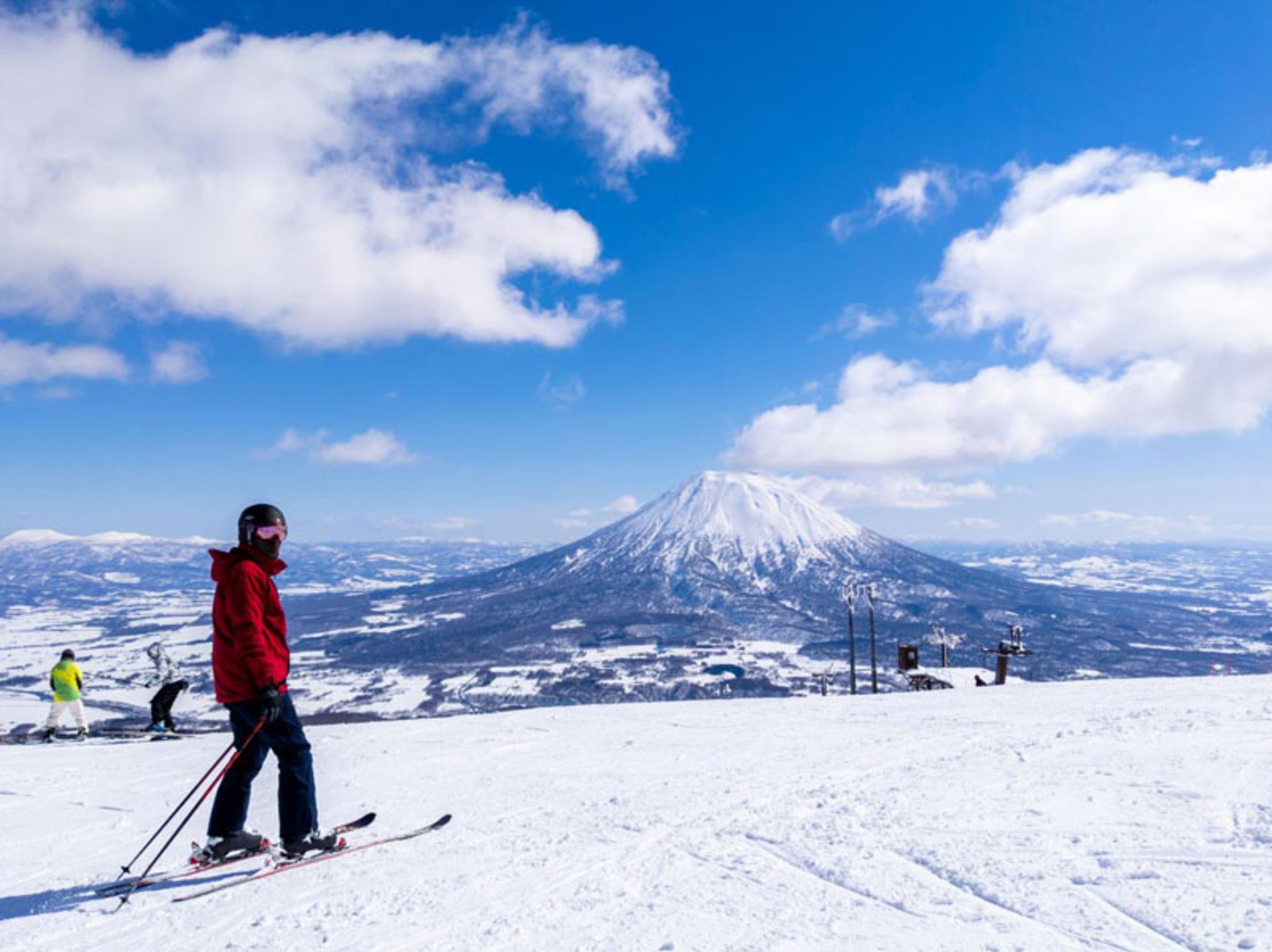 A skier watching a volcanic mouain in Hokkaido, Japan