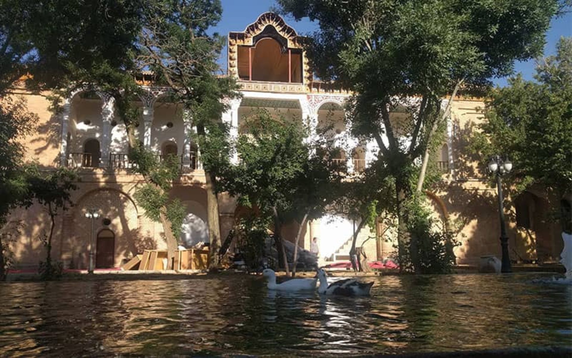 Khosroabad mansion with a water pond in fro of it