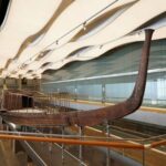 The beautiful effect of the curvature of the ship's wooden nose in the modern space of the museum