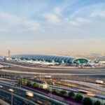 Aerial view of the runway and terminal of Dubai International Airport during the day