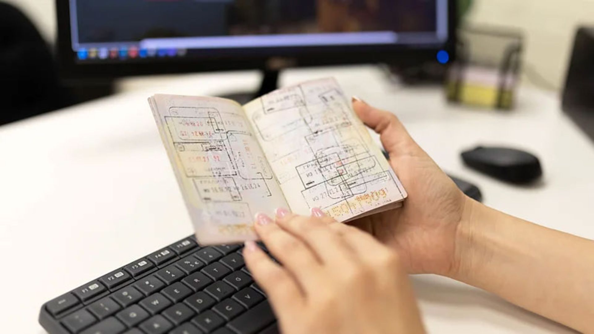 Stamped pages of a passport in a person's hand