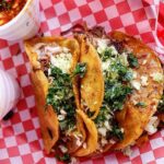 Two taco sandwiches on a square table